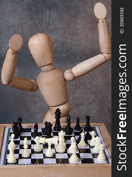 Wooden mannequin figure playing game of chess. Wooden mannequin figure playing game of chess.
