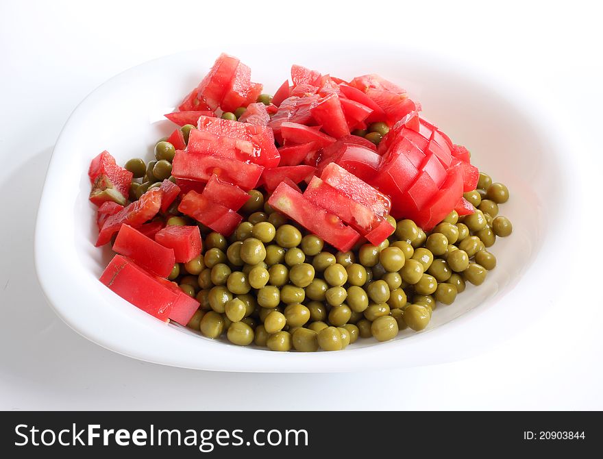 Color photograph of green peas and tomato. Color photograph of green peas and tomato