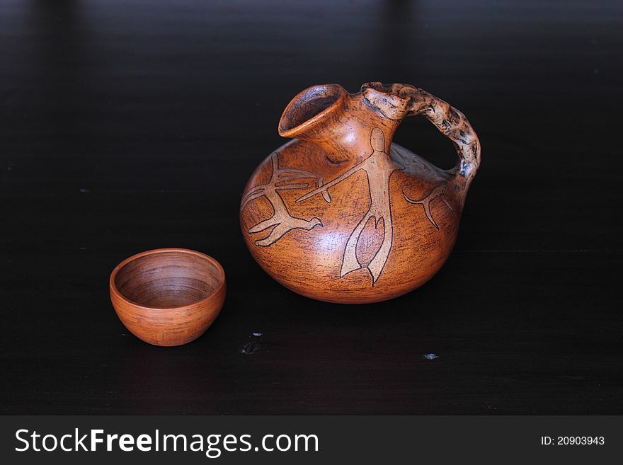 Clay jar and bowl on dark background