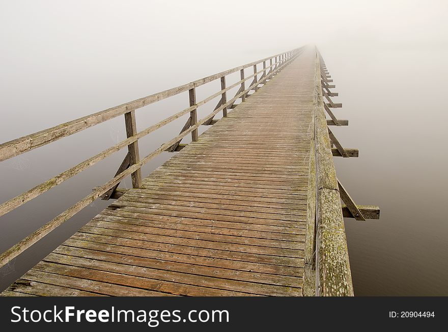 Wooden brigde perspective and morning mist. Wooden brigde perspective and morning mist
