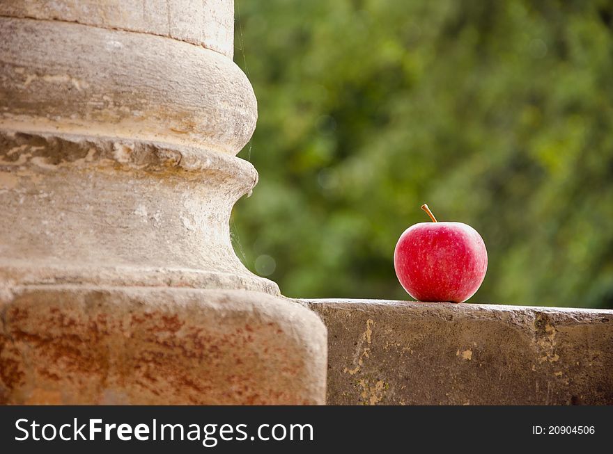 Red apple and old historical column. Red apple and old historical column