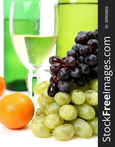 Wine and grapes on a white background