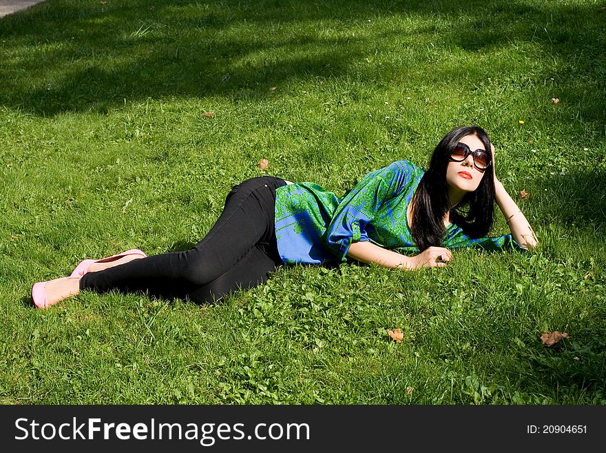 Girl lying on grass in park