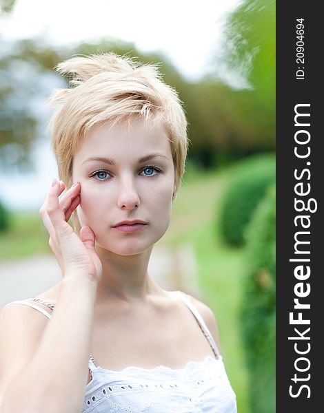 Portrait of young female posing on the nature. Model stroking her body. Portrait of young female posing on the nature. Model stroking her body