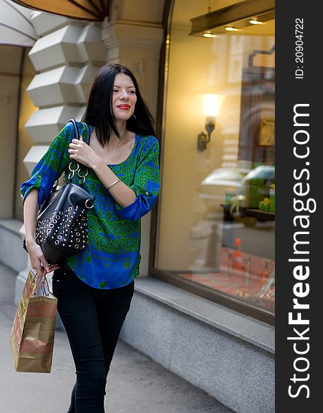 Shopping girl walking outdoor in city