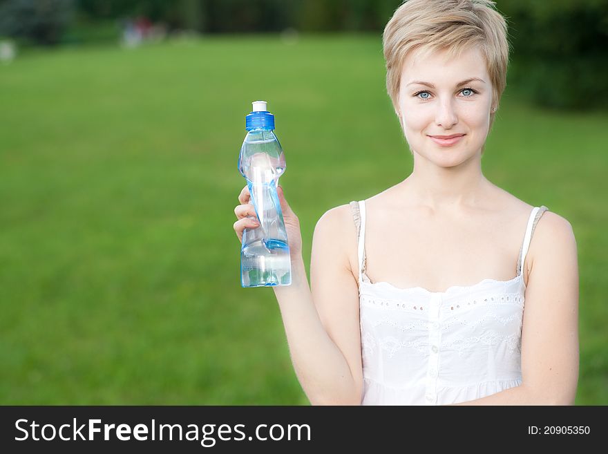 Portrait of lovely girl holding bottle of water in hand. Portrait of lovely girl holding bottle of water in hand