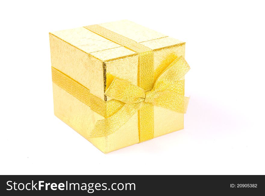 Christmas golden gift-box on white background, with golden ribbon. Christmas golden gift-box on white background, with golden ribbon