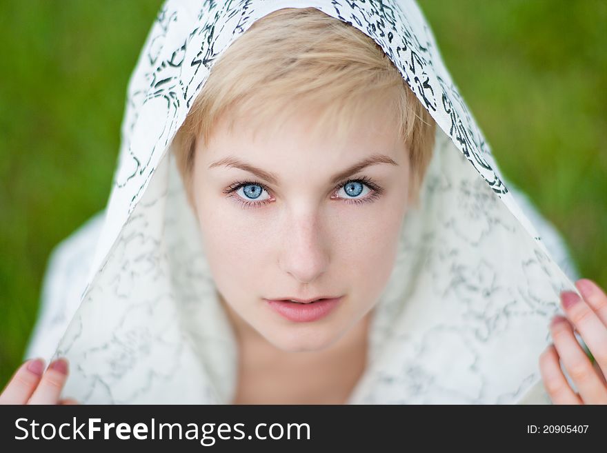 Closeup portrait of young woman with blue eyes close up facing camera outside in autumn. Closeup portrait of young woman with blue eyes close up facing camera outside in autumn