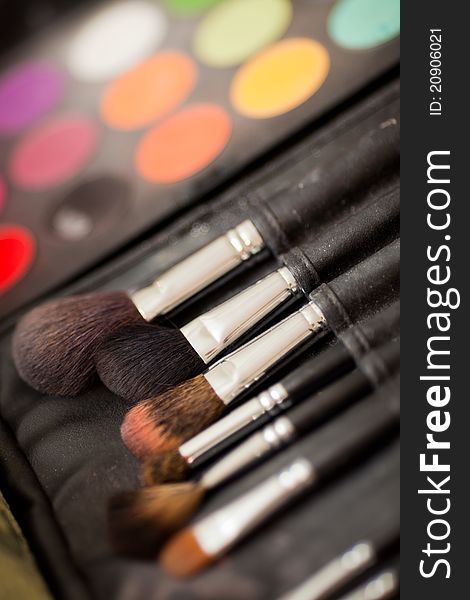 multicolored eye shadows with cosmetics brush. multicolored eye shadows with cosmetics brush