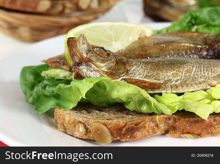 Smoked sprats on a slice of bread