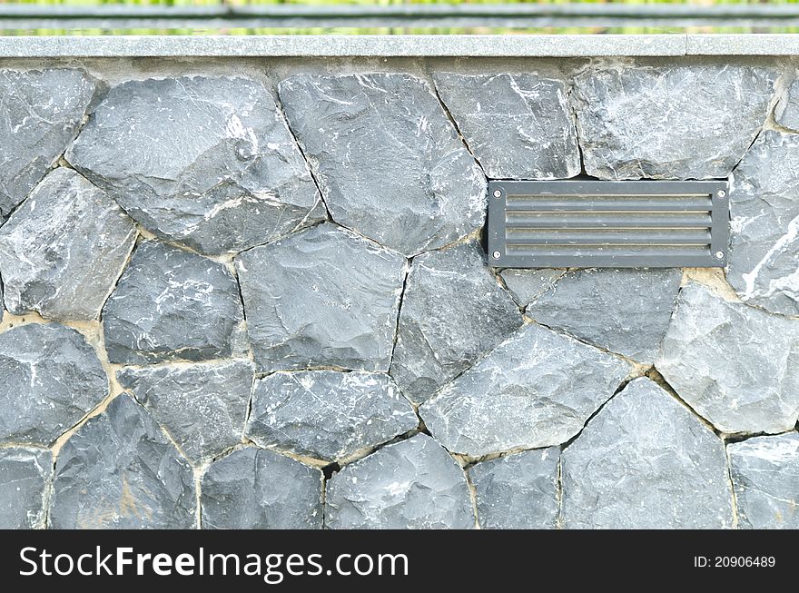 Electric lamp with gray stone wall background