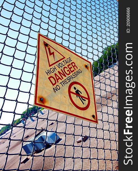 An high voltage-Danger sign on a fence. An high voltage-Danger sign on a fence