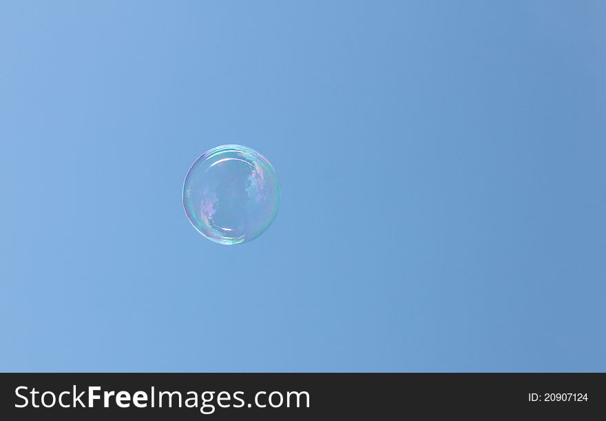 Bubble floating in the sky reflecting the sun and clouds. Bubble floating in the sky reflecting the sun and clouds