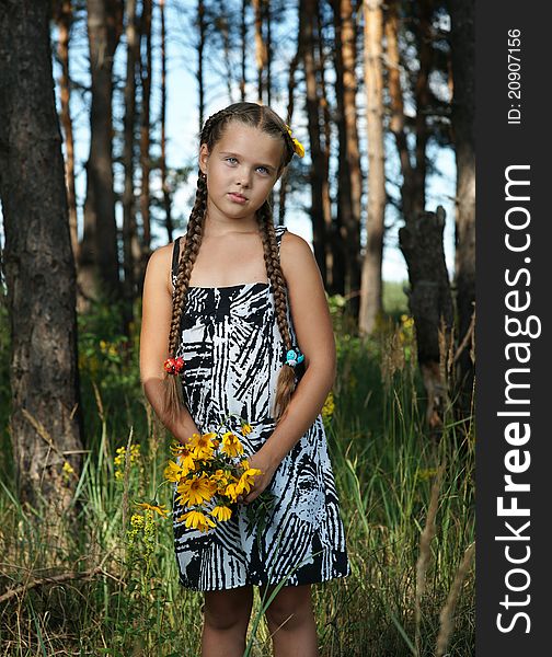 The girl in wood with a bunch of flowers