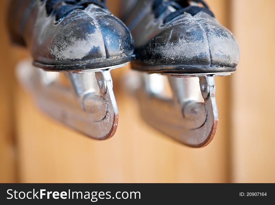 Old hockey skates hanging on the wall. Old hockey skates hanging on the wall