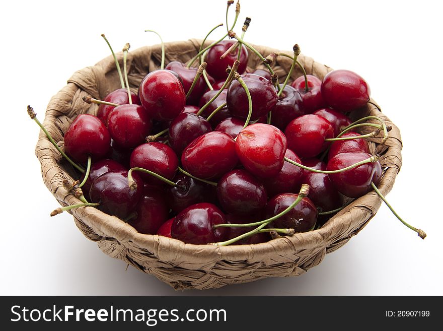 Red cherries with stem in the basket. Red cherries with stem in the basket