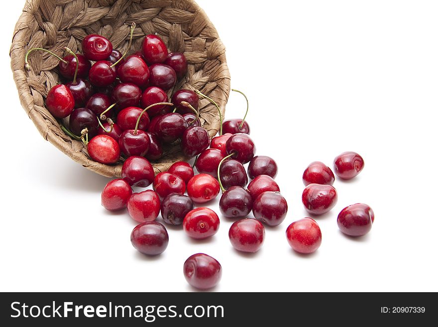 Red cherries with stem in the basket