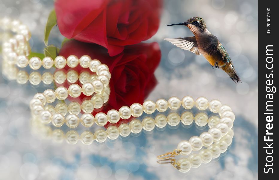 Hummingbird and Elegant pearls over glass with clouds and rose very shallow depth of field