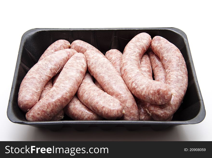Coarse raw fried sausages in the plastic packaging