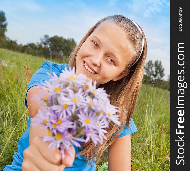 The girl camomile, sitting on a green grass. The girl camomile, sitting on a green grass