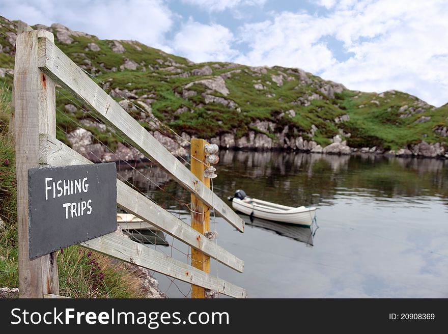 Fishing trips sign at a bay with scenic view in county kerry ireland. Fishing trips sign at a bay with scenic view in county kerry ireland