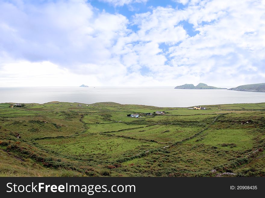 Green irish fields and skellig rock view