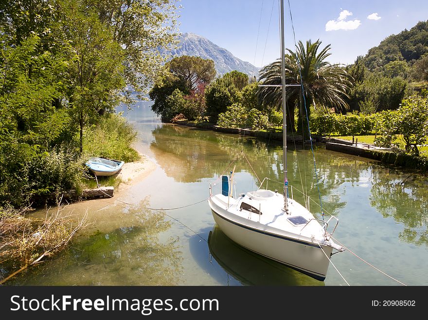 Small beauty sailing boat. Canal in Montenegro. Small beauty sailing boat. Canal in Montenegro.