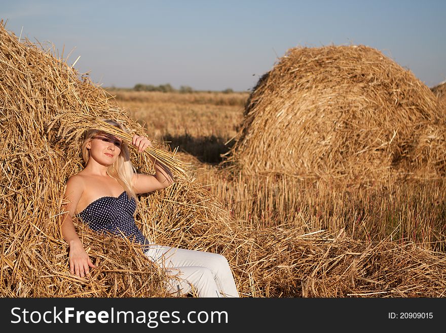 The beautiful girl in the field with wheat