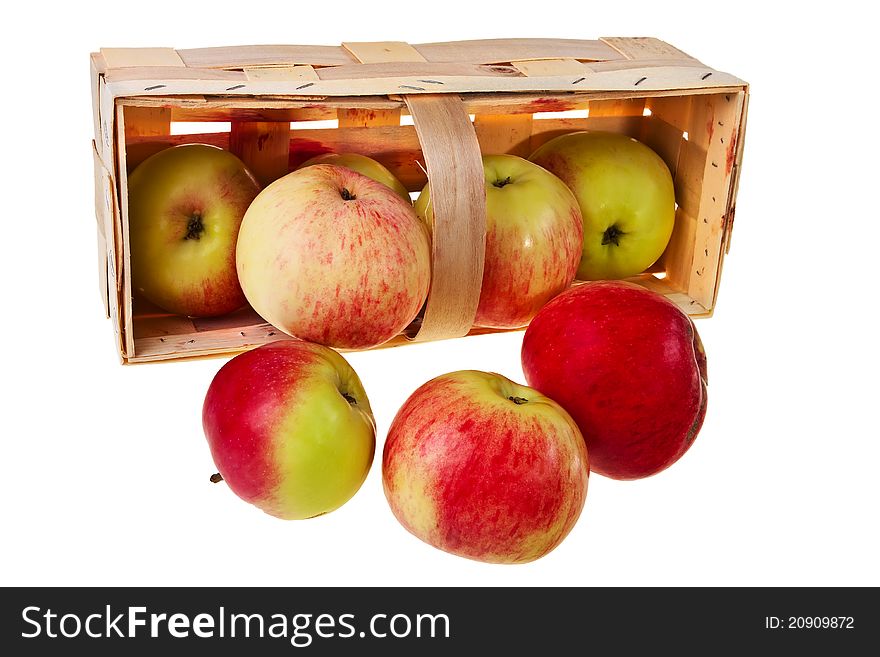 Fresh green, red apples in wooden basket.