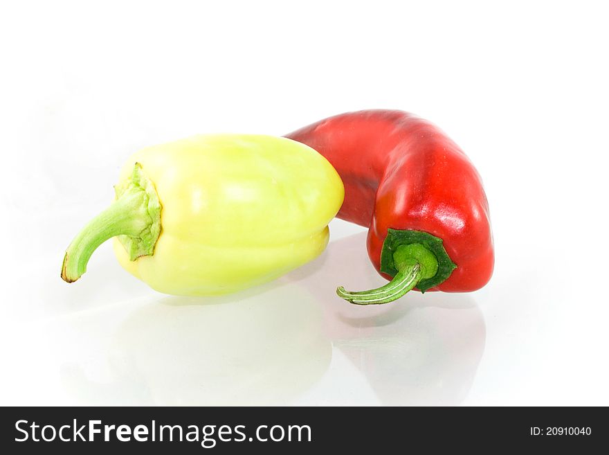 Studio shot of two peppers, red and yellow