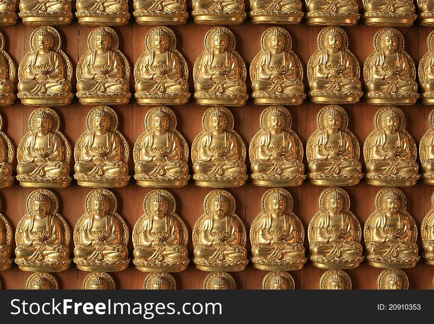 Many Gold Buddha Sculptures On The Wall