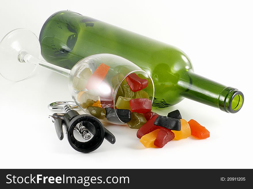 Colourful wine gum candy in glass bottle and corkscrew, isolated on white. Colourful wine gum candy in glass bottle and corkscrew, isolated on white