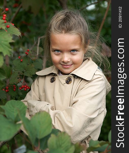 The little girl in guelder-rose bushes