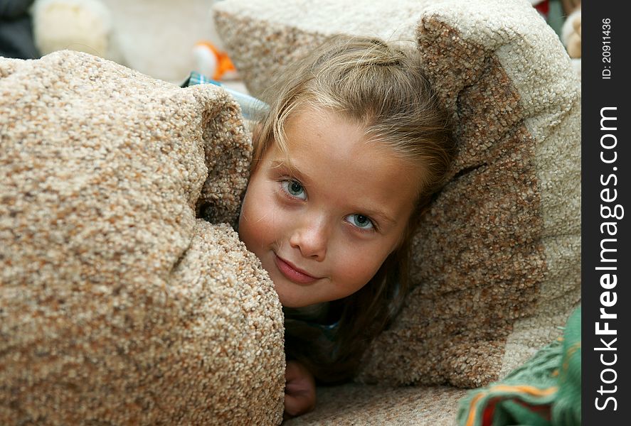 The little girl has hidden in pillows