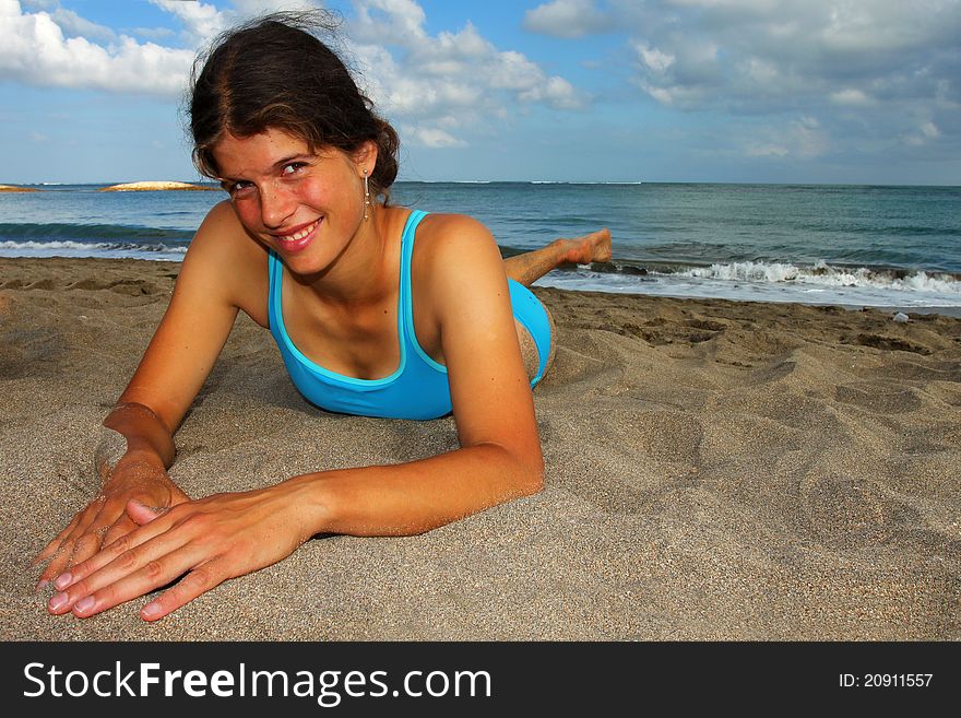 Happy young woman lying on the beach. Happy young woman lying on the beach