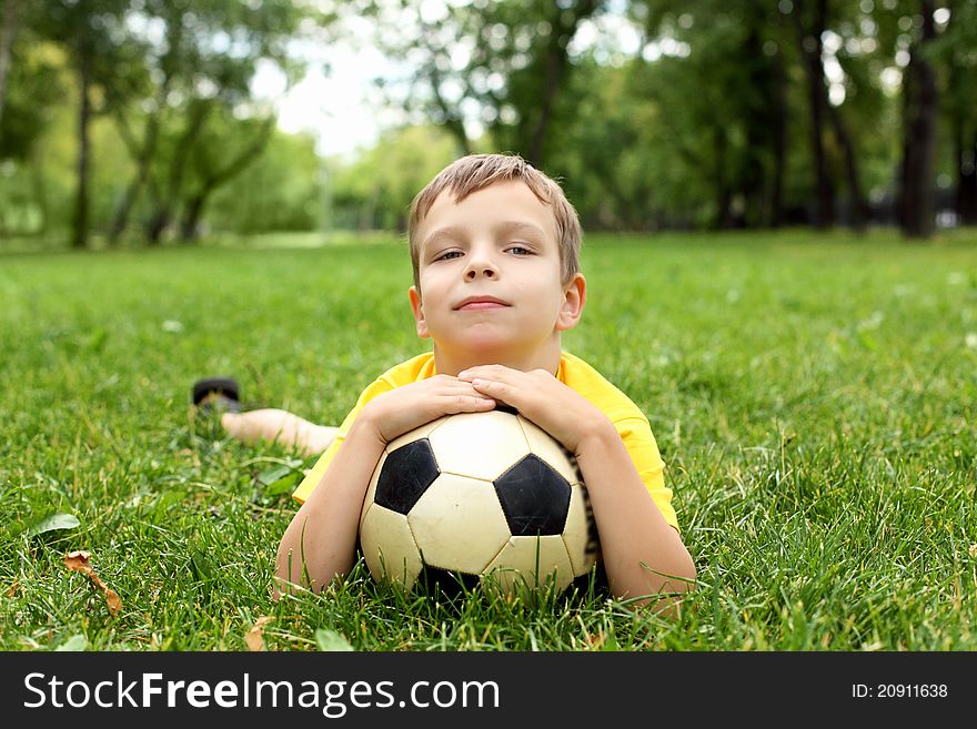 Little boy in the park with a ball