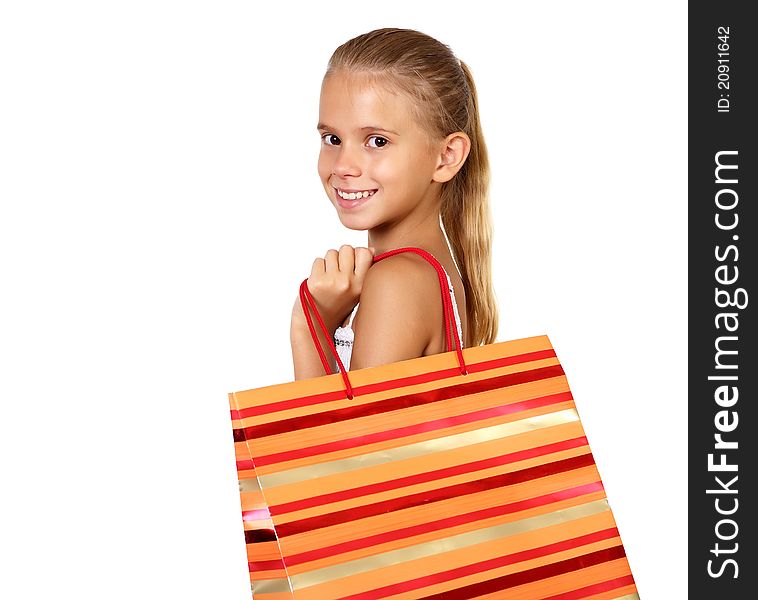 Pretty teenage girl with shopping bags in studio against white background