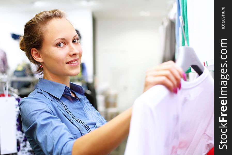 Woman in a shop buying clothes