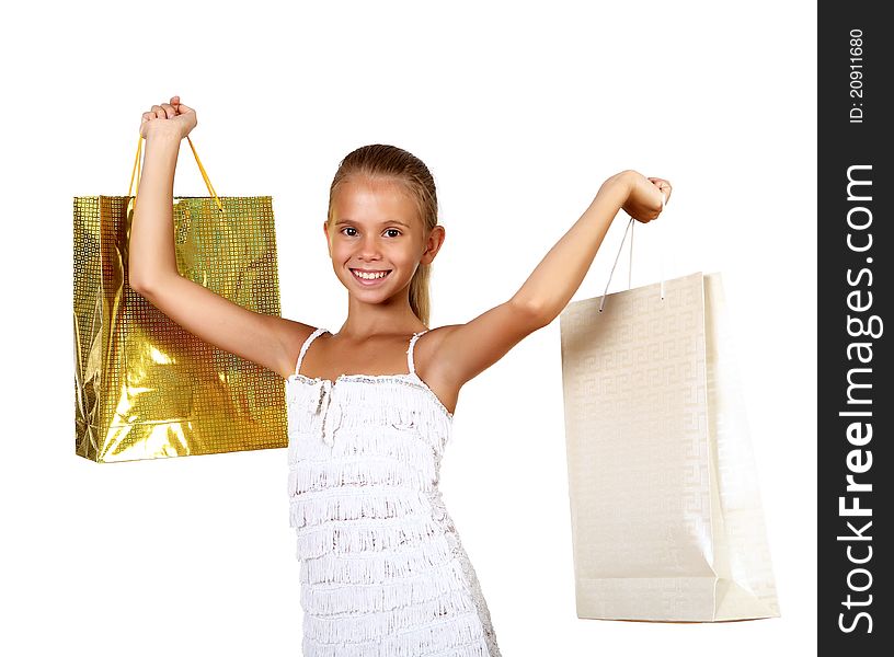 Pretty teenage girl with shopping bags in studio against white background