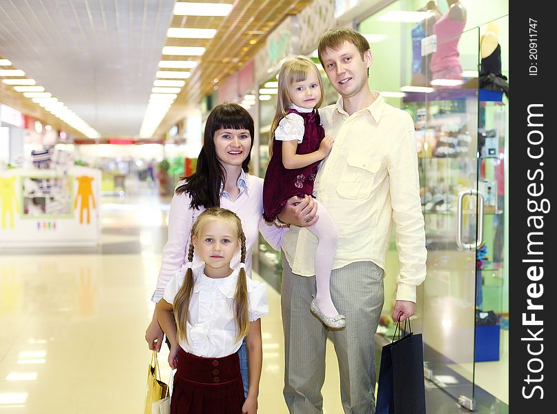 Young family with shopping bags doing shopping. Young family with shopping bags doing shopping