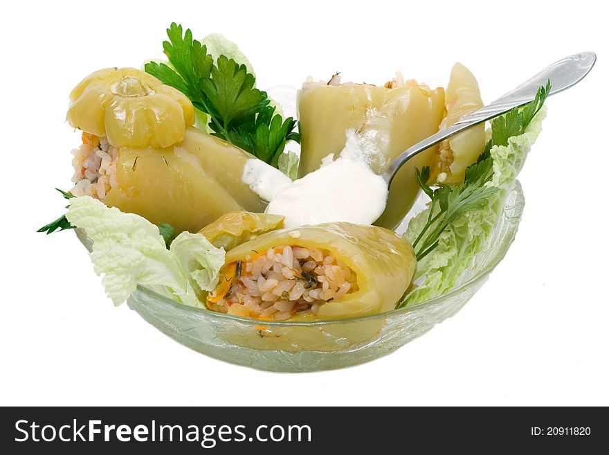 Stuffed peppers with a lettuce leaf on a white plate,