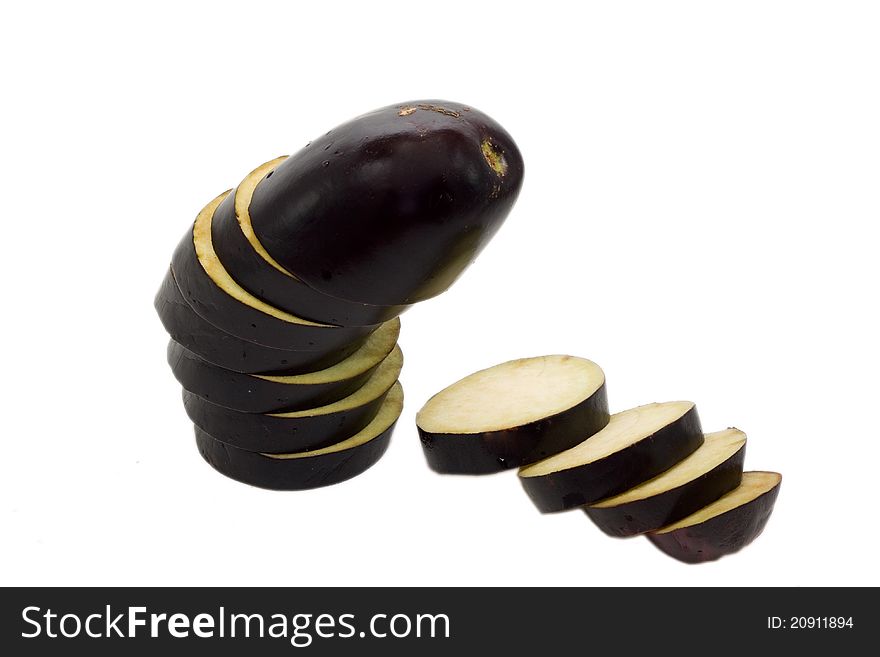 A partially sliced aubergine isolated in white background