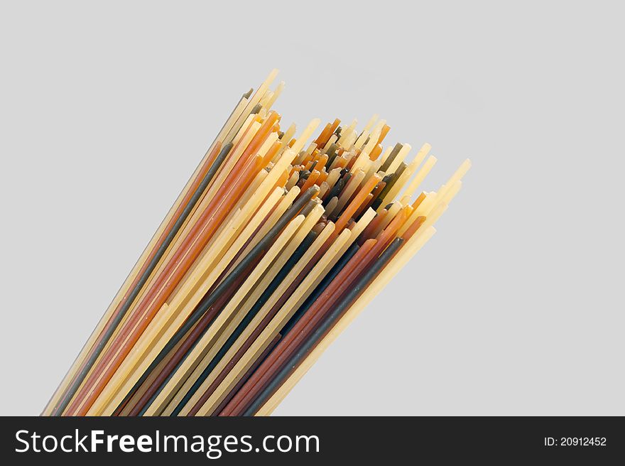 Raw colour spaghetti isolated on grey background
