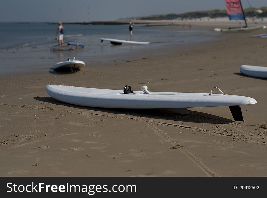 Surfboards lying in sand at the beach