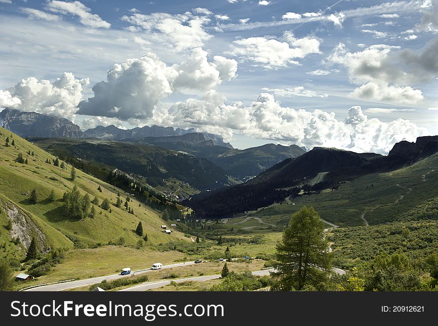 Summer overview of the Italian Dolomites and a small barn in the foreground. Summer overview of the Italian Dolomites and a small barn in the foreground