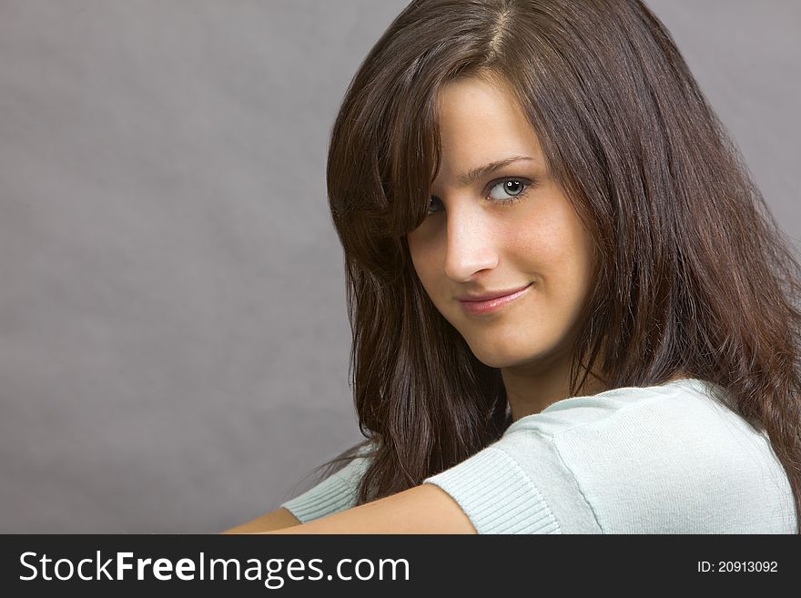 An attractive young brunette woman with a smile