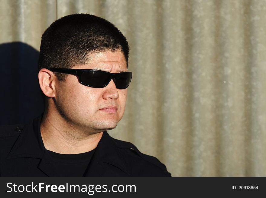A police officer with a serious look on his face.