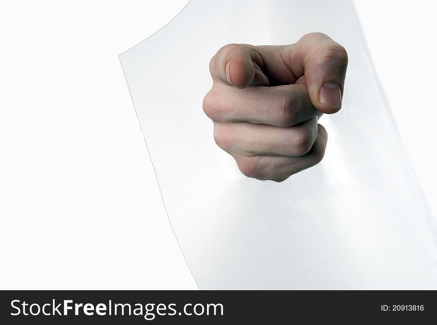 Hand pointing through a piece of paper on white background