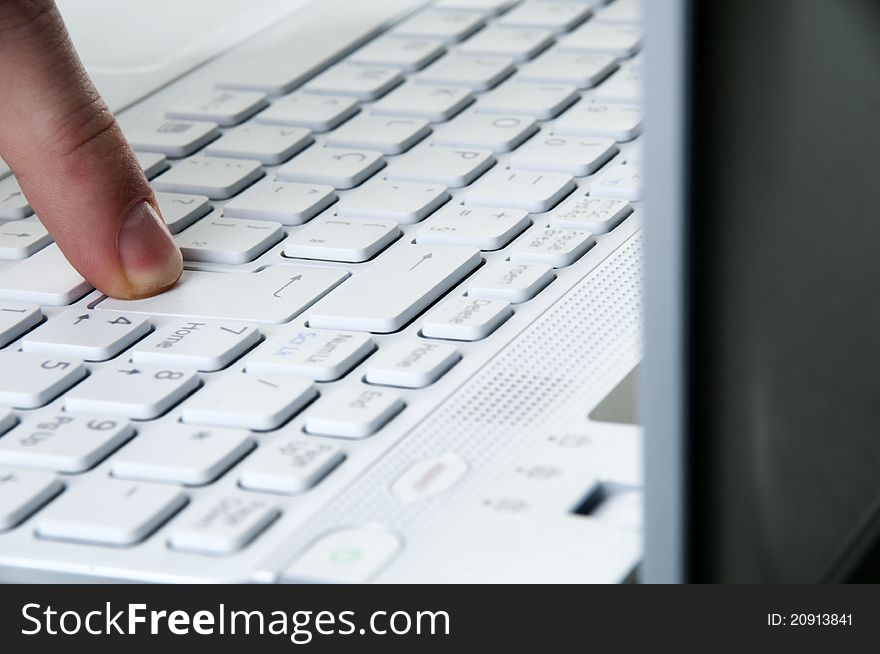 Close up of the enetr key on a laptop being pressed. Close up of the enetr key on a laptop being pressed