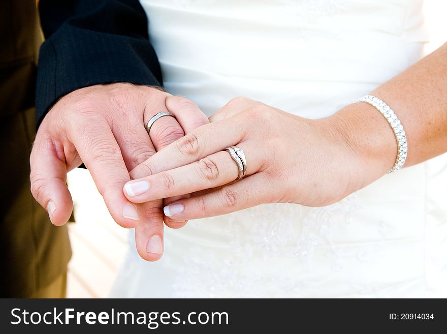 A caucasian couple showing off their wedding rings. A caucasian couple showing off their wedding rings